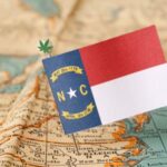 Map of North Carolina pinned with a miniature flag.