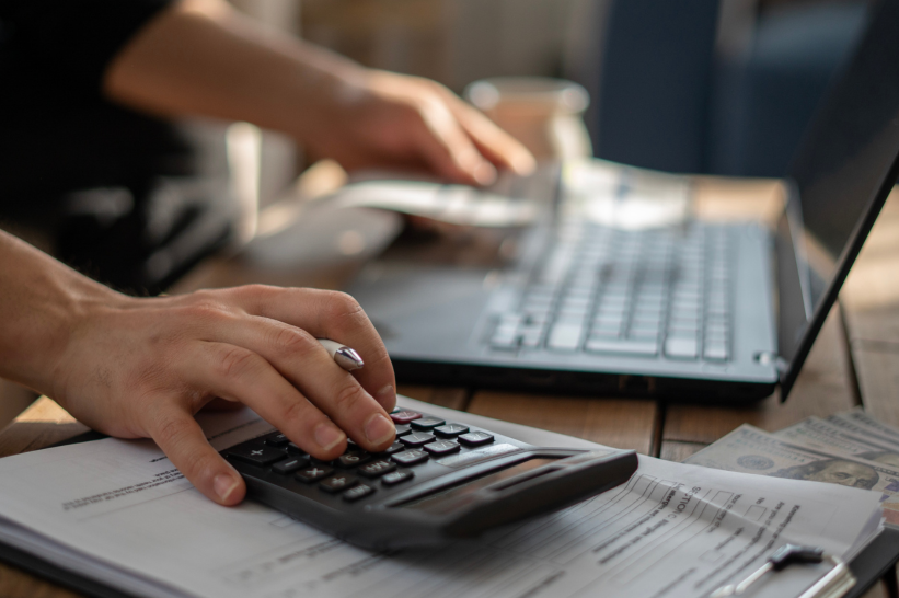 A man computing his expenses for a dispensary