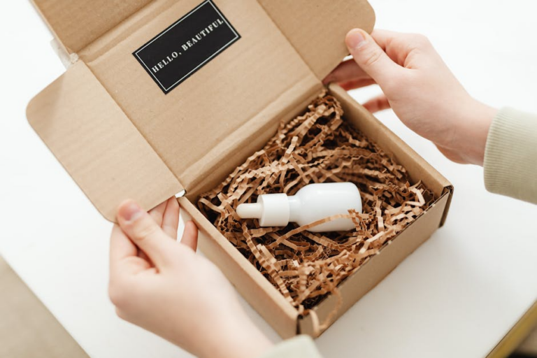 A hand opening a box with a cannabis tincture inside